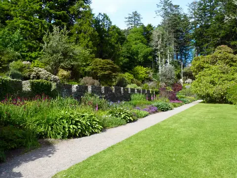 Neat lawn edge beside a path and garden beds